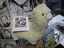 An Alpaca doll with a QR code